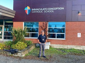 Michael Bellmore, chair of the Sudbury Catholic District School Board, shows off the board's new signs at Immaculate Conception Catholic School in Val Caron. Supplied