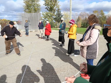 Local Anishinaabe/Ojibway artist and educator Will Morin builds a Dream Catcher with the help of participants at a Fridays For Future Sudbury event outside Science North in Sudbury, Ont. on Friday October 22, 2021. Morin was invited to the event to lead the group in an Indigenous teaching circle. The event was held in conjunction with the Fridays For Future international day of action. John Lappa/Sudbury Star/Postmedia Network
