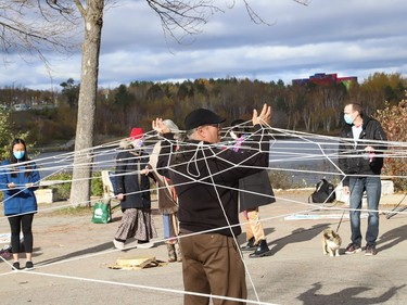 Local Anishinaabe/Ojibway artist and educator Will Morin builds a Dream Catcher with the help of participants at a Fridays For Future Sudbury event outside Science North in Sudbury, Ont. on Friday October 22, 2021. Morin was invited to the event to lead the group in an Indigenous teaching circle. The event was held in conjunction with the Fridays For Future international day of action. John Lappa/Sudbury Star/Postmedia Network