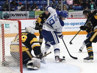 Kosta Manikis, middle, of the Sudbury Wolves, attempts to deflect the puck past goalie Tristan Malboeuf, of the Hamilton Bulldogs, during OHL action at the Sudbury Community Arena in Sudbury, Ont. on Friday October 22, 2021. John Lappa/Sudbury Star/Postmedia Network