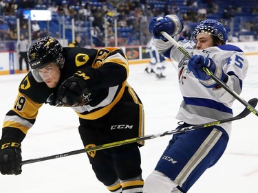 Ethan Larmand, right, of the Sudbury Wolves, and Jan Mysak, of the Hamilton Bulldogs, collide during OHL action at the Sudbury Community Arena in Sudbury, Ont. on Friday October 22, 2021. John Lappa/Sudbury Star/Postmedia Network