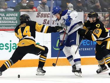 Chase Stillman, middle, of the Sudbury Wolves, attempts to skate between Nathan Staios, left, and Jonathan Melee, of the Hamilton Bulldogs, during OHL action at the Sudbury Community Arena in Sudbury, Ont. on Friday October 22, 2021. John Lappa/Sudbury Star/Postmedia Network