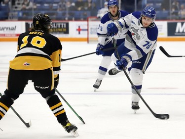 Andre Anania, right, of the Sudbury Wolves, fires the puck past Gavin White, of the Hamilton Bulldogs, during OHL action at the Sudbury Community Arena in Sudbury, Ont. on Friday October 22, 2021. John Lappa/Sudbury Star/Postmedia Network