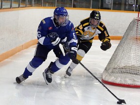 Greater Sudbury Cubs defenceman Cole Quevillon (6) plays the puck behind his team's net while Soo Eagles forward Jack Mortson (16) gives chase during first-period NOJHL action at Gerry McCrory Countryside Sports Complex in Sudbury, Ontario on Thursday, October 28, 2021.