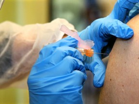 A pharmacist administers a flu shot last November. While influenza wasn't rampant in 2020, experts are warning the virus could be much more prevalent this year.