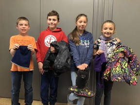 Taking part in an annual Winter Clothing Drive in 2019 were R.H. Murray Public School students, from left, James Lair, Brogan Hurley, Akiyanna Nishihata-Akavak and Lindsay Fournier. This year residents are encouraged to drop off items at Canadian Tire locations.