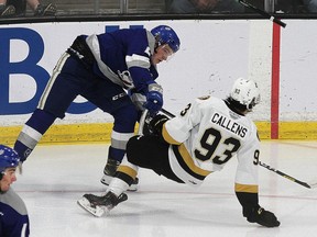 Kingston Frontenacs Maddox Callens gets knocked down by Joshua Hoover Sudbury Wolves during Ontario Hockey League action at the Leon's Centre in Kingston on Friday October 15, 2021. Ian MacAlpine/Kingston Whig-Standard/Postmedia Network