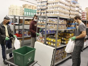South Porcupine Food Bank volunteers, from left, Gerald Blais, Devon Dysart and Kevin Kilgour were restocking the shelves as the food bank moved to its new permanent location on Saturday at 97 Bloor St. next to the C.M. Shields Centennial Library. 

RICHA BHOSALE/The Daily Press