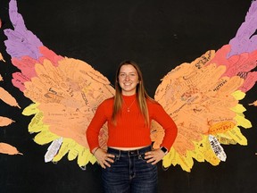 A large art installation was the centerpiece of Simcoe Composite School's celebration of the first annual National Truth and Reconciliation Day on Sept. 30. Posing with this set of wings – each feather inscribed by students with a personal message of reconciliation – is Charlie Ellis, a member of SCS's social media club. Monte Sonnenberg/Postmedia Network