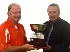 Senior Men's League champion Mike Willoughby (left) is presented with the championship trophy by co-owner of The Greens at Renton, Steve Williams. (Submitted)