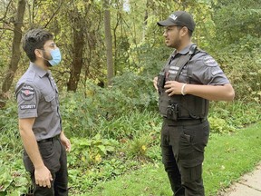 CanCom Security guards Keshav Gubta (left) and Hardik Goyal were protecting a wooded area off Glenwood Drive on Oct. 15 where human remains, which were found in August 2020, have been named the first case for the task force investigating the historical deaths of children at the Mohawk Institute. Susan Gamble/Postmedia