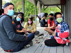 Alex Robertson (left), CEO of Camp Ooch-Camp Trillium, has confirmed that the amalgamated camping-recreation programmer for young people recovering from cancer has re-branded itself as Campfire Circle. The new name takes effect Jan. 1. Here, Robertson plays games with campers this summer at the former Camp Trillium on Rainbow Lake in Waterford. Contributed photo