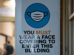 A face masks required sign at a university dorm. File photo