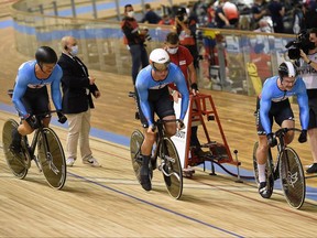 Nick Wammes, centre, of Bothwell, Ont., competes with Canadian teammates Hugo Barrette and Ryan Dodyk in the men's team sprint qualifying during the UCI track cycling world championships at Jean-Stablinski velodrome in Roubaix, France, on October 20, 2021. (Photo by FRANCOIS LO PRESTI/AFP via Getty Images)