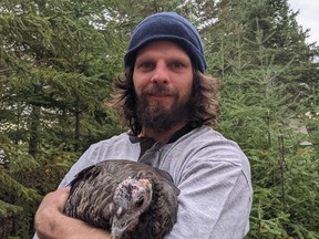 Christian Joseph Symanyk holds a turkey at a healing camp he's staying at.