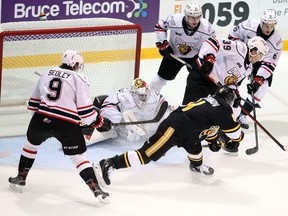 Max Namestnikov is surrounded by defenders while Colby Barlow tries to clear the puck and goaltender Mack Guzda sprawls on the goalline in the first period as the Owen Sound Attack host the Sarnia Sting inside the Harry Lumley Bayshore Community Centre Saturday, October 30, 2021. Greg Cowan/The Sun Times