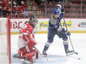 Sudbury Wolves forward Landon McCallum (11) tries to control a puck in front of Soo Greyhounds goaltender Samuel Ivanov during OHL action at GFL Memorial Gardens in Sault Ste. Marie, Ontario on Saturday, October 9, 2021.