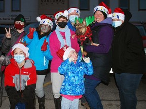 The Turner family of Tara, including French bulldog Remy wearing green antlers, pose for a photo before the start of the 76th annual Kiwanis Owen Sound Santa Claus Parade last year. DENIS LANGLOIS