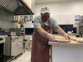Tod Russell, coordinator of the 2021 meat pie fundraiser for the Royal Canadian Legion Branch 599 in West Ferris, puts some meat pies into the oven Monday. This year the branch will have made more than 100,000 meat pies since 1989-1990.