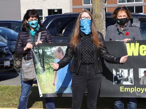 Melodie Berube, middle, of the Sudbury Workers' Education and Advocacy Centre, makes a point at the Ontario Network of Injured Workers Groups rally outside of Sudbury MPP Jamie West's office in Sudbury, Ont. on Friday October 29, 2021. John Lappa/Sudbury Star/Postmedia Network