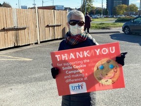 Trenton Memorial Hospital Foundation volunteer Pat Lafferty holds a sign thanking Tim Hortons teams Tuesday in Trenton. Six of the chain's restaurants raised more than $46,000 for the foundation.