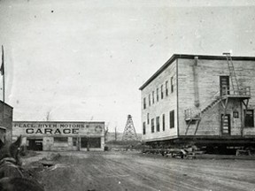 •	77.801.30 – The Royal Hotel, built in 1915 by W.R. Gibbs, owned by the Lipseys, now on Main Street after a challenging move across the Heart River in 1932. It was destined for Lots 29, 30 and 31 on east side of street across from McNamara Hotel. Note railway ties under the structure, dirt road, wooden sidewalk. The 1908 ferry tower remains in background on south side of the river. It held the east bank cable for the ferry, whose usefulness was terminated following the completion of the railway bridge in 1918.