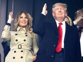 ATLANTA, GEORGIA - OCTOBER 30:  Former first lady and president of the United States Melania and Donald Trump do "the chop" prior to Game Four of the World Series between the Houston Astros and the Atlanta Braves Truist Park on October 30, 2021 in Atlanta, Georgia. (Photo by Elsa/Getty Images) *** BESTPIX ***