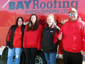 Bay Roofing employees Kassandra Servello, left, Manon Delorme, Christine Aird and owner Mark Weckwerth helped collect more than 10,000 pounds of food for the North Bay Food Bank.
PJ Wilson/The Nugget