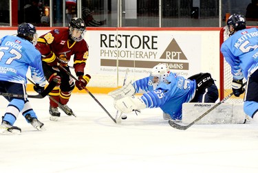 Cochrane Crunch goalie Ben DiGiallonardo pounces on a rebound before Timmins Rock forward Nicolas Pigeon can get his stick on the puck as teammates Benjamin Orgil, left, and Dylan McKittrick look on during Friday night’s NOJHL contest at the McIntyre Arena. The Rock got goals from eight different players, including Pigeon, and went on to defeat the Crunch 8-2. THOMAS PERRY/THE DAILY PRESS