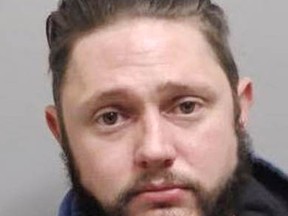 Adam Horn, 33, surrendered to police Nov. 4. He faces charges related to explosives and a prohibited weapon.