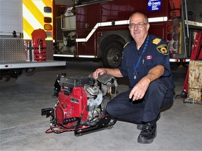 Powassan Fire Chief Bill Cox with the 18 horsepower water pump the local department recently acquired through Firefighters Without Borders. The unit goes for about $5,000 new. It will go into service later this month.
Rocco Frangione Photo
