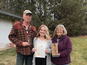 Parkland County's Meagan Chapman, centre, is joined by her parents after she received the province's first Spirit Award, presented as part of the 2021 Minister's Seniors Service Awards, given to individuals, organizations or businesses for their service to seniors in Alberta.