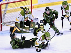 Simon Rose of the North Bay Battalion tumbles over Maddox Callens of the Kingston Frontenacs in Ontario Hockey League action Friday night. Goaltender Joe Vrbetic and Alexander Lukin of the Troops and Kingston's Christopher Thibodeau keep eyes on the play.
Submitted Photo