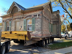 The historic Crystal Cottage of Chatham Street in Brantford successfully completed the first leg of its journey Sunday to its eventual new home at the Brant Museum and Archives three blocks away on Charlotte Street. The whimsical structure features more than 330 old bottles incorporated into the brickwork on three sides as well as under the front window sills. – Monte Sonnenberg