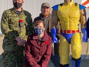 Cold Lake Air Force Museum Chair Major Kael Rennie (left), artist Jonjo Nally, and in front curator Wanda Stacey from the Cold Lake Air Force Museum. Photo by Tanya Boudreau