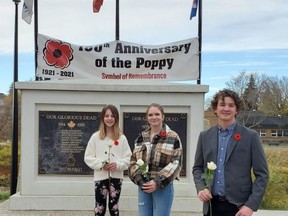 (Centre) Thirteen-year-old Callie Bizuk of Sherwood Park, joined Olivia Walsh (left), 10, and Reid Maxwell (right), 14, both of St. Albert, took a trip to the cenotaph in St. Albert for a moment of silence at the end of October. Photo Supplied