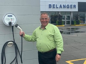 Nickel Belt MP Marc Serre shows off an EV charging station in Chelmsford.