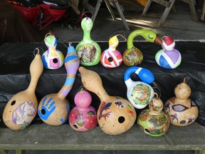 Colourful birdhouse gourds decorated by FOY members with decoupage and or paint.