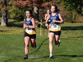 Angela Mozzon (49) and Sarah Booth (48) comepete for Laurentian University at the OUA Cross-Country Running Championships in London, Ont. on Saturday, November 6, 2021.