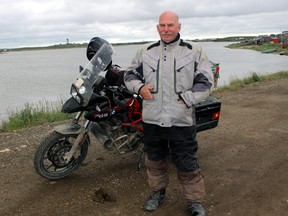 Larry Simpson stands with one of the motorcycles he's used in his travels, and which led to the book A Road Goes There.
Submitted Photo