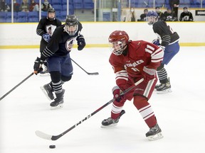 St. Charles Cardinals forward Gavin Roy (11) handles the puck during SDSSAA boys hockey action against the Lasalle Lancers at Garson Arena in Garson, Ont. on Wednesday, November 10, 2021. St. Charles won 6-0.