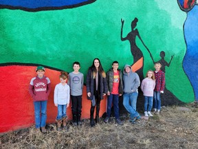 Beautifying Blackie
The Blackie Community Mural is complete after about seven months and many hours of painting and hard work. Christi Tims along with her TraXside Studios art students and various members and groups of the community were all big supporters and helped make this project succeed. Here, on Nov. 5 in front of the mural Denton Machan, (left to right) Kaitlynn Machan, Hudson Koster, Christi Tims, Cade Koster, Hayden Machan, Lyla Fath and Elle Umscheid