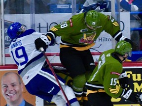 Alexander Lukin of the visiting North Bay Battalion checks Kosta Manikis of the Sudbury Wolves in the second period of their Ontario Hockey League game Friday night. Manikis was taken off the ice on a gurney, but there was no penalty on the play for the clean check.
Sean Ryan Photo