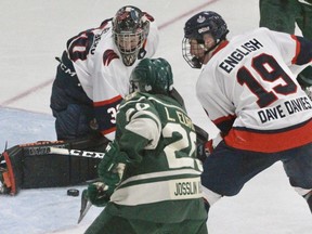 Stratford Warriors' goalie Marcus Vandenberg makes a save off Elmira Sugar Kings' forward Luke Eurig, while Stratford defenceman Jesse English looks to clear the loose puck during the third period of the GOJHL game Friday night at the Allman.