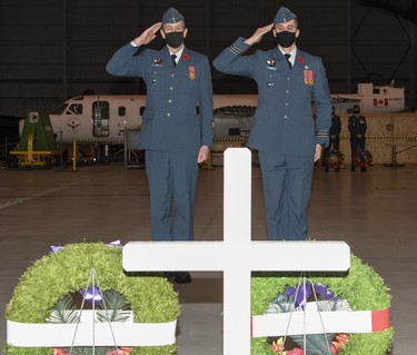 The Aerospace Engineering Test Establishment (AETE) acting unit Chief Warrant Officer, Master Warrant Officer Dennis Tobin (left) and AETE acting Commanding Officer Lieutenant Colonel Jean-Michel Racine salute After the laying of the Canadian Armed Forces wreath, during the Remembrance Day Ceremony held at 1 Air Maintenance Squadron on November 11, 2021 at 4 WIng Cold Lake.