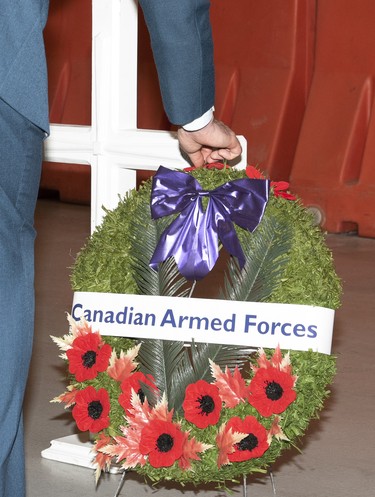 a Soldier places his poppy upon the Canadian Armed Forces wreath during this years Remebrance Day ceremony held at 1 Air Maintenance Squadron on November 11, 2021 at 4 Wing Cold Lake.