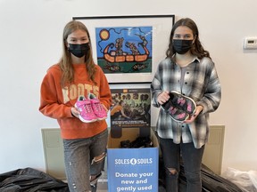 Participating in a shoe collection for the Souls4Soles campaign are Grade 12 Lo-Ellen students Jill Kusnierczyk, left, and Evie Tomlin.