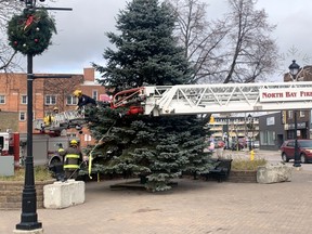 Members of the North Bay Fire and Emergency Services spent Tuesday morning helping decorate the Christmas tree in the parkette at Fraser Street and Main Street West. The Downtown Improvement Area cancelled the annual Christmas Walk due to COVID-19 rules. The traditional tree-lighting ceremony takes place Thursday at 6 p.m.
Jennifer Hamilton-McCharles, The Nugget