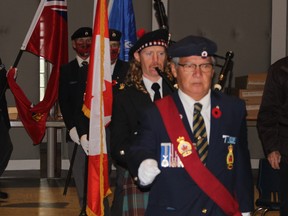 Sgt. at Arms Fred White leads the colour party into the ceremony.