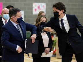 Prime Minister Justin Trudeau (right) and Alberta Premier Jason Kenney bump elbows during a joint federal-provincial announcement of $10-a-day daycare at Boyle Street Plaza in Edmonton on Monday, Nov. 15. IAN KUCERAK/Postmedia